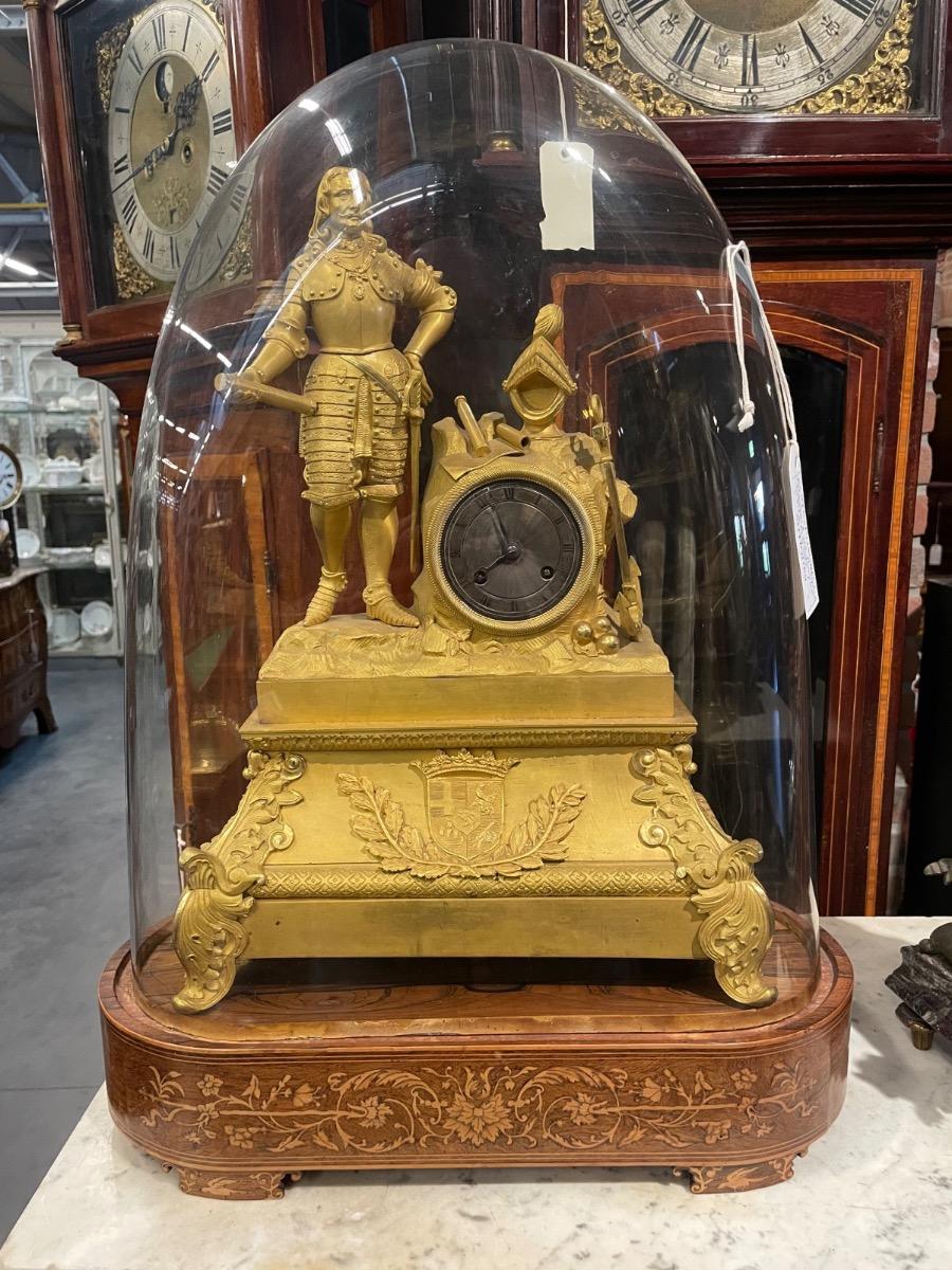 A Michiel de Ruyter bronze gilded mantle clock under glass dome