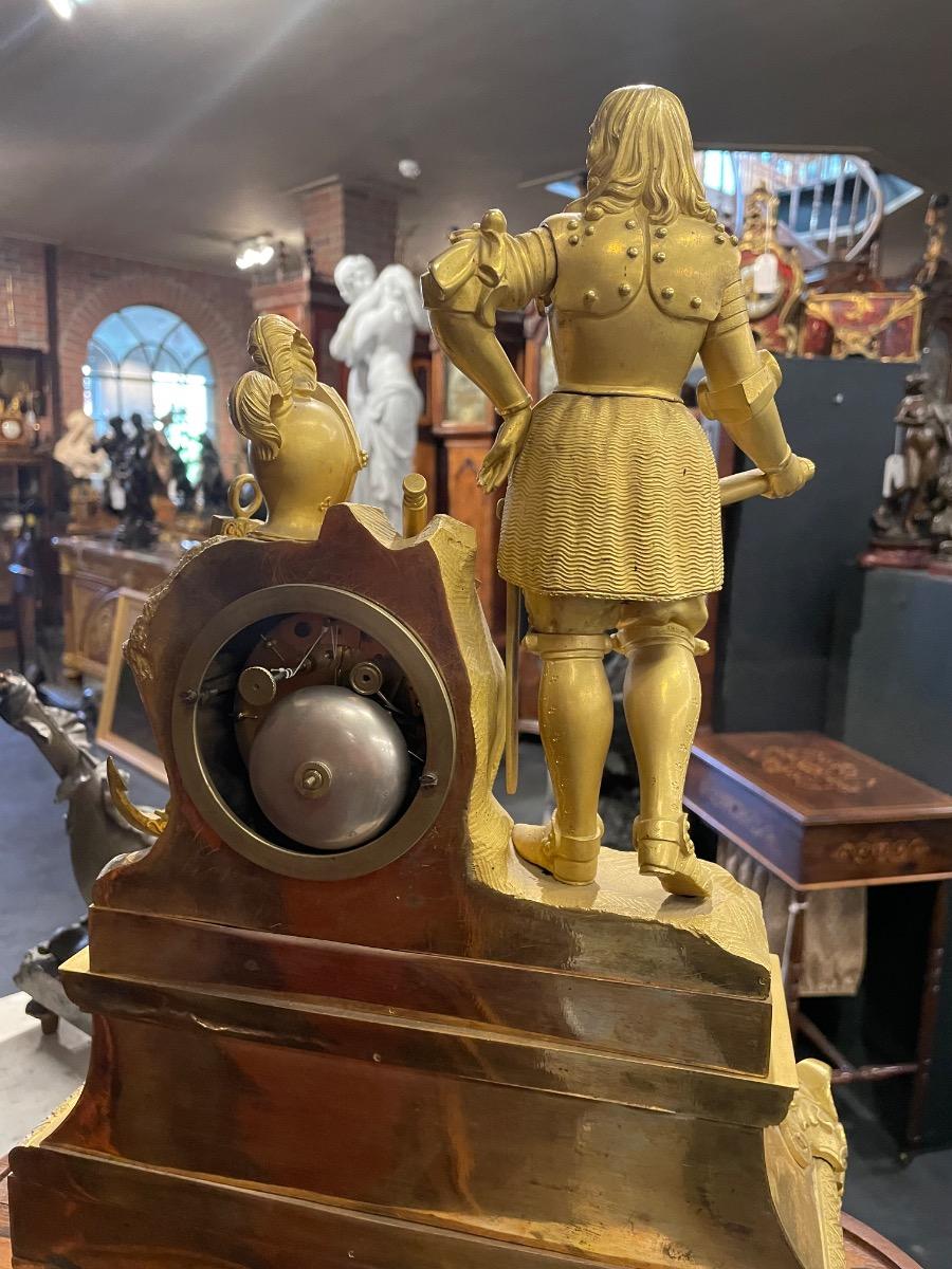 A Michiel de Ruyter bronze gilded mantle clock under glass dome